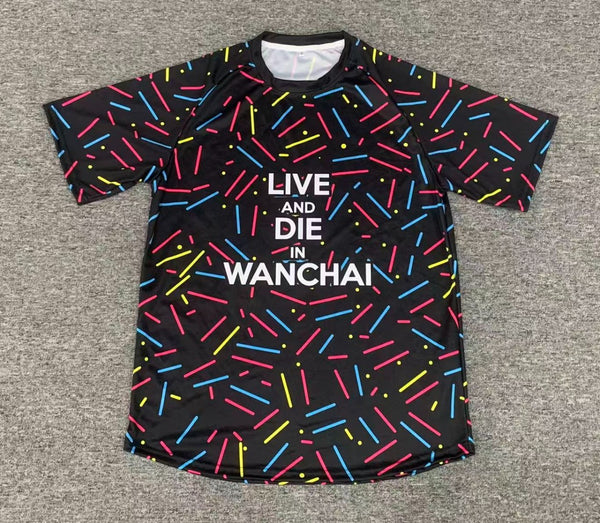 A black short-sleeved T-shirt covered in a pattern of coloured sprinkles, with the words Live and die in Wanchai across the chest.