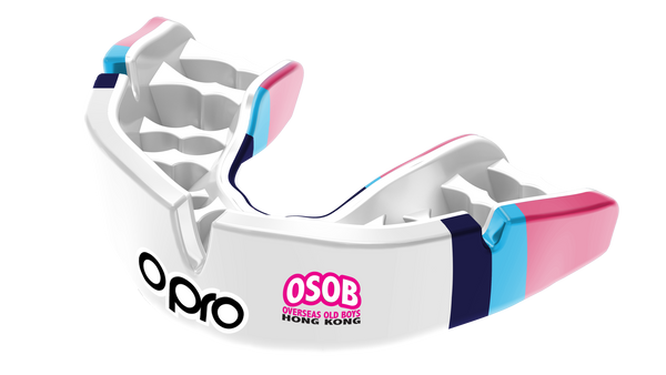 A white mouthguard with pink, blue and navy stripes, carrying a club logo.